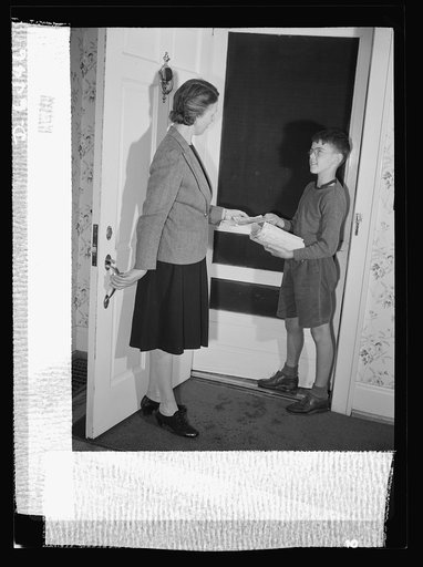 Manpower, junior size. "Any scrap for Uncle Sam?" Captain Charles Wentworth, a junior commando in Roanoke, Virginia, hands Mrs. John Farr a leaflet announcing the hunt for precious metal and rubber. Units of three children to a block combed every house for scrap and brought it to their own houses wh
