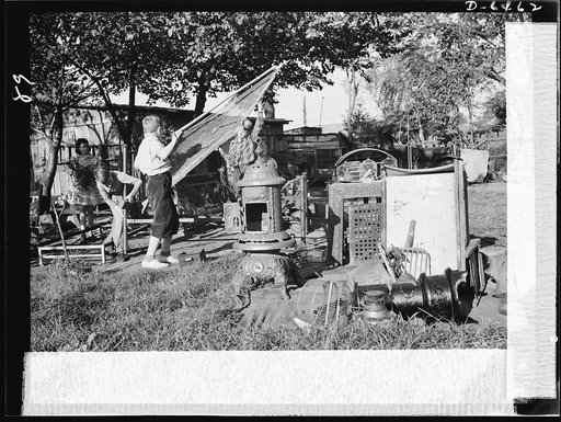 Manpower, junior size. A couple of husky junior commandos add to a neighborhood scrap pile in Roanoke, Virginia. Bedsprings, coal buckets, bird cages, stoves--no piece of unused metal is safe from the hands of these patriotic youngsters, who are out to see that their older brothers in the armed forc