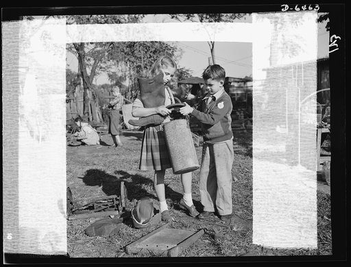 Manpower, junior size. It takes a good right arm to collect all the household scrap that's needed for the nation's armaments, and these Roanoke, Virginia youngsters have just what it takes. Note the badge on the boy's collar; it reads "Lieutenant: Junior Commando Salvage Drive"