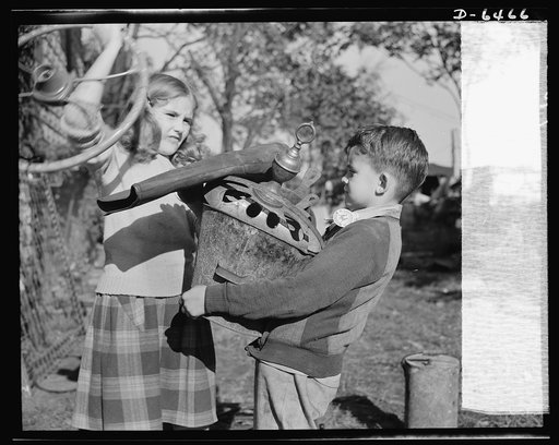 Manpower, junior size. It takes a good right arm to collect all the household scrap that's needed for the nation's armaments, and these Roanoke, Virginia youngsters have just what it takes. Note the badge on the boy's collar; it reads: "Lieutenant: Junior Commando Salvage Drive"