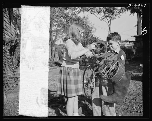 Manpower, junior size. It takes a good right arm to collect all the household scrap that's needed for the nation's armaments, and these Roanoke, Virginia youngsters have just what it takes. Note the badge on the boy's collar; it reads: "Lieutenant: Junior Commando Salvage Drive"