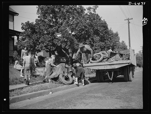 Manpower, junior size. What's a home without its sidewalk scrap pile? Junior commandos of Roanoke, Virginia see to it that each home has given enough scrap to make the scrap collectors monthly visit worthwhile. When the truck appears, every youngster in the neighborhood pitches in to help load it