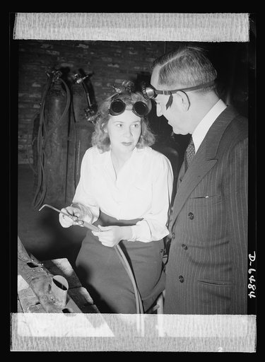 Montgomery Blair High school Victory Corps. Montgomery Blair High School girls are being trained for positions in war industry. As part of the Victory Corps activities in this Silver Spring, Maryland school, Shirley Noonan learns how to weld. John Studebaker, U.S. Commissioner of Education, watches 