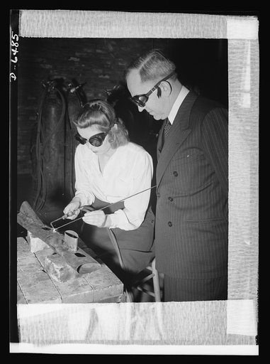 Montgomery Blair High school Victory Corps. Montgomery Blair High School girls are being trained for positions in war industry. As part of the Victory Corps activities in this Silver Spring, Maryland school, Shirley Noonan learns how to weld. John Studebaker, U.S. Commissioner of Education, watches 