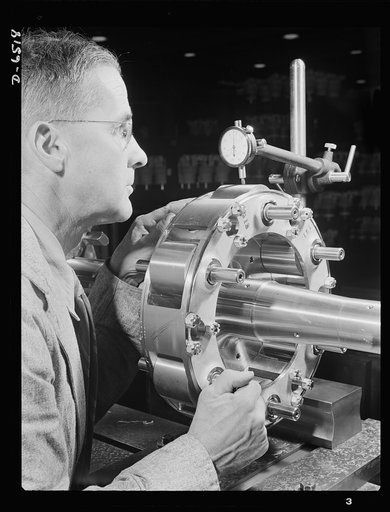 Production. Pratt and Whitney airplane engines. A propeller shaft of a Pratt and Whitney airplane engine is carefully checked for concentricity in a large Eastern plant steadily producing at a high rate for our armed forces. Pratt and Whitney Aircraft