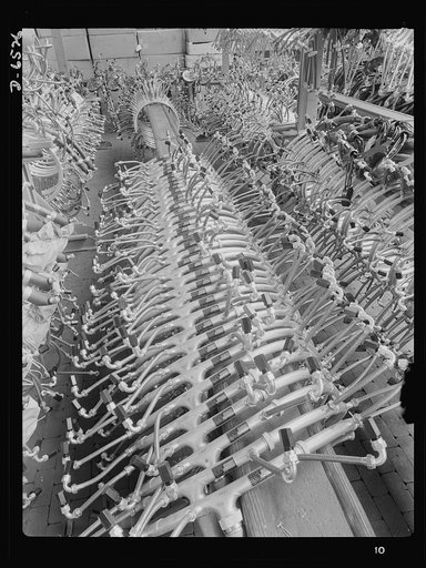 Production. Pratt and Whitney airplane engines. Ignition harnesses ready for assembly in Pratt and Whitney airplane engines form an interesting pattern on the racks of a large Eastern plant working steadily at the important job of powering the planes of our armed forces. Pratt and Whitney Aircraft