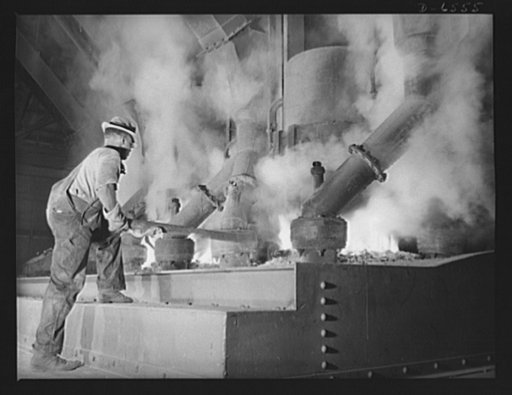 Tennessee Valley Authority production. Elemental phosphorus. A Negro worker tending an electric phosphate smelting furnace which is producing elemental phosphorus at a TVA chemical plant in the Muscle Shoals area. The phosphorus, used in the manufacture of incendiary bombs and shells and of material