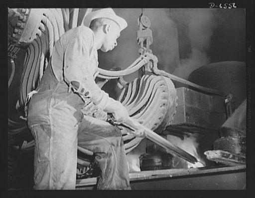 Tennessee Valley Authority production. Elemental phosphorus. A Negro worker tending an electric phosphate smelting furnace which is producing elemental phosphorus at a TVA chemical plant in the Muscle Shoals area. The phosphorus, used in the manufacture of incendiary bombs and shells and of material
