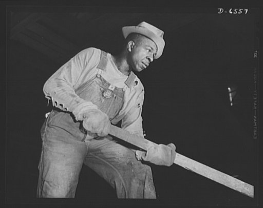 Tennessee Valley Authority production. Elemental phosphorus. A Negro worker tending an electric phosphate smelting furnace which is producing elemental phosphorus at a TVA chemical plant in the Muscle Shoals area. The phosphorus, used in the manufacture of incendiary bombs and shells and of material