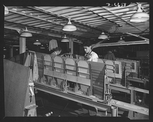 Production. Lockheed P-38 pursuit planes. Beginning construction of a center section of a Lockheed P-38 pursuit plane in a Western aircraft plant. Here the trailing edge of a center section is "mated" to the main beam. On a final assembly line, the completed center section will be joined to other pl