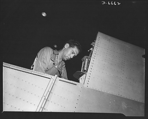 Production. Lockheed P-38 pursuit planes. A mechanic in a large Western aircraft plant at work on a center section for a Lockheed P-38 pursuit plane. On a final assembly line, the completed center section will be joined to other plane sections, and noses, engines, wings, landing gear and other equip