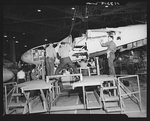 Production. Lockheed P-38 pursuit planes. A partly-finished Lockheed P-38 pursuit ship, including center and nose section, is swung over a rolling cradle to begin its trip down the assembly line of a large Western aircraft plant. As the ship moves from station to station along this line it will rece