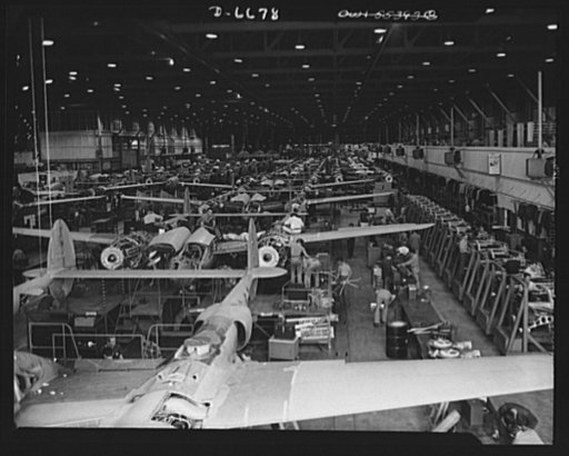 Production. Lockheed P-38 pursuit planes. An overall assembly line where Lockheed P-38 pursuit ships take shape in a large Western aircraft plant. To the left is an identical line on which British "Lightning" ships are made. At the right is a long line of Allison liquid-cooled engines of a kind that