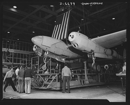 Production. Lockheed P-38 pursuit planes. A new Lockheed P-38 pursuit plane, complete except for propellers, is hoisted from a station stand in a large Western aircraft plant assembly line. From here, the ship will be rolled to the testing field where the propellers will be installed and trial fligh