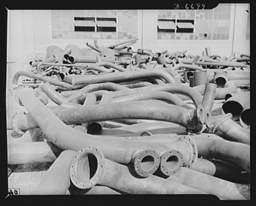 Manpower. Southern shipyard workers. Soon they'll be part of a fighting ship. These steel and copper tubing shapes will be installed in U.S. Navy vessels now under construction in a Southern shipyard