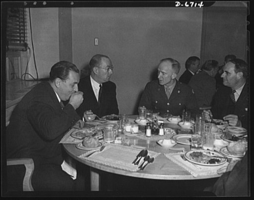 Dehydrated foods. Top war agency officials lunch on dehydrated foods--the kind of food that is being sent overseas to save shipping space. From left to right: Leon Henderson, Price Administrator; Donald M. Nelson, Chairman of the War Production Board (WPB); Brigadier General Carl Hardigg, Office of 