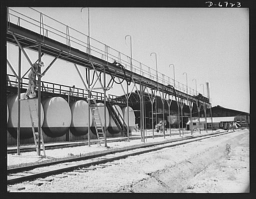 Production. Tin smelting. Acid tanks at a Southern tin smelter--the finest and most modern plant in the world. The acid is used in one of the processes of separating the tin from the impurities in the ore. Construction is still going on at this plant, which has already achieved a heavy output of the