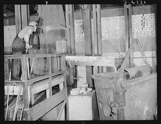 Production. Tin smelting. Removing slag after tapping a furnace in a Southern tin smelter. The tin extracted from the ore has already been drawn off into floats for further refining. The slag is then run off to the right into ladles which will carry it to recooking operations. The slag is reintroduc