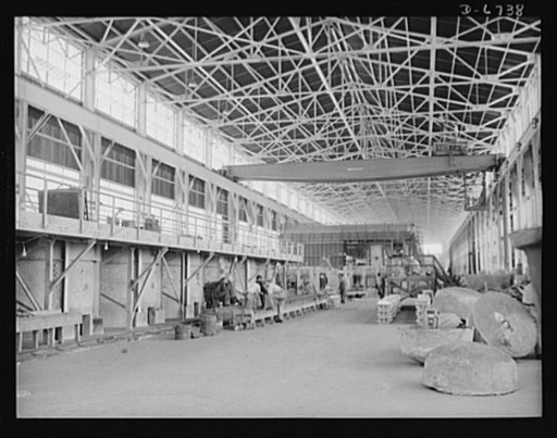 Production. Tin smelting. A section of the smelting or furnace building of a large Southern plant in which pure tin is extracted from South American ore. At the left is a row of "pot boilers" in which the pure tin is kept at a temperature of about 750 degrees Fahrenheit until it is poured into molds