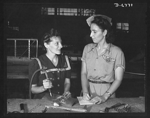 Naval air base, Corpus Christi, Texas. Pearl Harbor widows have gone into war work to carry on the fight with a personal vengeance. Mrs. Virginia Young (right), whose husband was one of the first casualties of World War II, is a supervisor in the ssembly and repairs department of the naval airbBase 