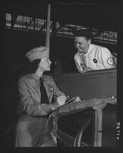 Naval air base, Corpus Christi, Texas. Formerly a sociology major at the University of Southern California, Mrs. Elouise J. Ellis (right) now "keeps 'em flyin'" at the naval air base in Corpus Christi, Texas. She is a supervisor under civil service in the assembly and repair department. It is her jo