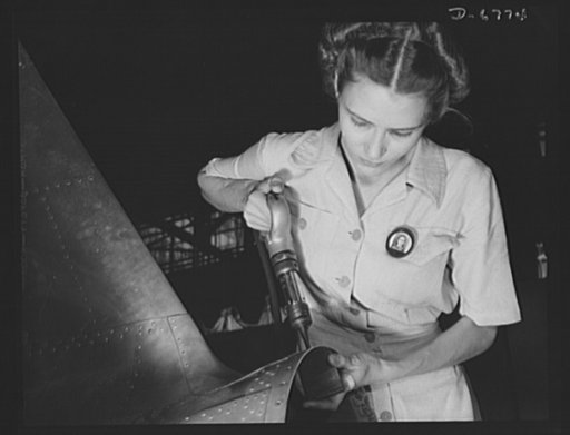 Naval air base, Corpus Christi, Texas. Answering the nation's need for womanpower, Mrs. Virginia Davis made arrangements for the care of her two children during the day and joined her husband at work in the naval air base in Corpus Christi, Texas. Both are employed under civil service in the assembl
