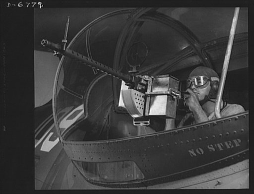 Naval air base, Corpus Christi, Texas. The target: the Axis! Jesse Rhodes Waller, Aviation Ordnance Mate, third class, tries out a thirty-caliber machine gun he has just installed in a Navy plane. Waller is stationed at the naval air base in Corpus Christi, Texas