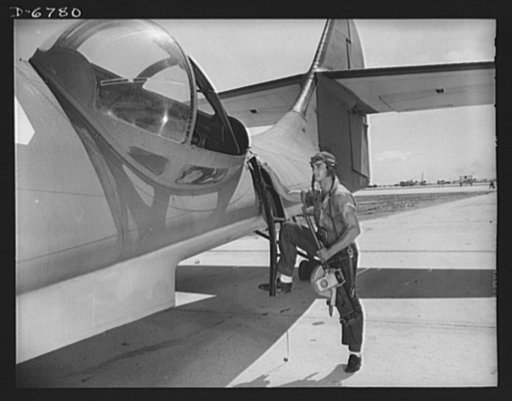 Naval air base, Corpus Christi, Texas. It's an intricate operation installing a thirty-caliber machine gun in a Navy PBY plane, but not too tricky for Jesse Rhodes Waller. He's a  Georgia man who's been in the Navy five and half years. At the naval air base in Corpus Christi, Texas, he sees that fly