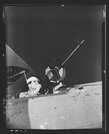 Naval air base, Corpus Christi, Texas. He'd like to use that gun on the Axis. After seven years in the Navy, J.D. Estes is considered an old sea salt by his mates at the Naval air base in Corpus Christi, Texas