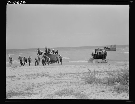Training. Ramp boats. Young sailors learn the art of making beach landings with ramp boats. To the right of the powerboat just discharging its landing party is a thirty-six-foot wooden ramp boat used to carry men, trucks and lighter field equipment. Off shore is a fifty-foot steel ramp boat capable 
