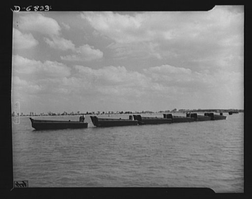 Production. Small ramp boats. A tow of wooden ramp boats used for landing men and equipment on beaches. These thirty-six-foot boats, just launched at a large Southern shipyard, will soon be delivered to the Navy. The high bottom-hinged sterns of these boats are used as ramps to make fast, dry-shod l