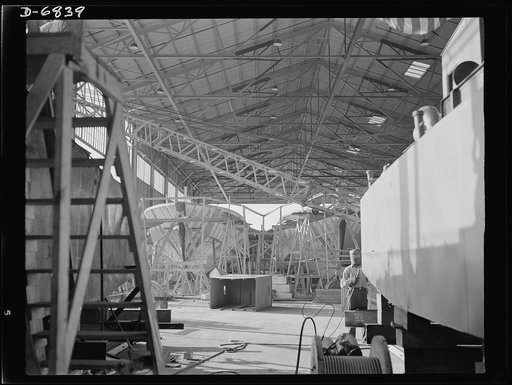 Production. Motor torpedo boats (wooden). Frames for motor torpedo boats under construction at a large Southern shipyard. These speedy seventy-eight-foot boats are built of prefabricated parts and sections under roof. When ready for launching and fitting they are moved to nearby water. In the right 
