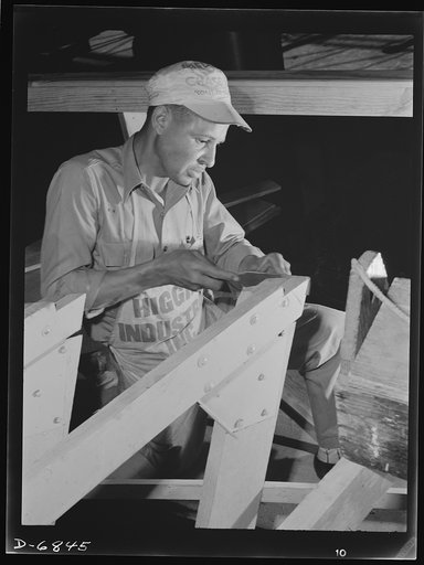 Production. Motor torpedo boats (wooden). A Negro carpenter working on the framing of a motor torpedo boat at a large Southern shipyard. These fast seventy-eight-footers are built indoors of prefabricated parts and sections. When the hulls are ready for launching and fitting they are moved from the 