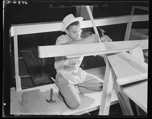 Production. Motor torpedo boats (wooden). A Negro carpenter working on the framing of a motor torpedo boat at a large Southern shipyard. These fast seventy-eight-footers are built indoors of prefabricated parts and sections. When the hulls are ready for launching and fitting they are moved from the 
