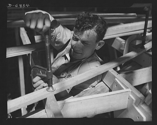 Production. Motor torpedo boats (wooden). Setting deck beam sections for a new seventy-eight-foot motor torpedo boat at a large Southern shipyard. These fast boats are built of prefabricated parts and sections under roof. When the hulls are ready for launching and fitting they are moved from the pla