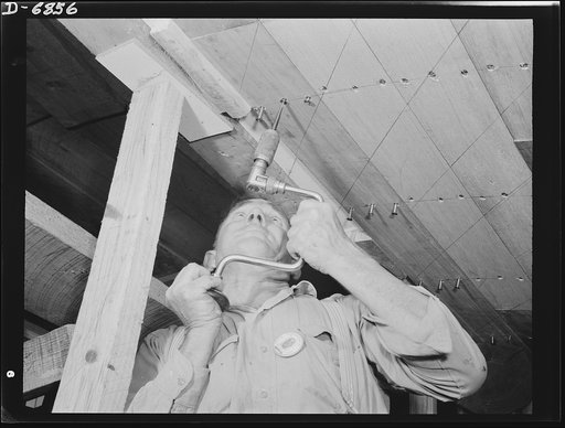 Production. Motor torpedo boats (wooden). Applying planking to a new seventy-eight-foot torpedo boat in a large Southern shipyard. The hulls of these speedy wooden boats are built indoors of prefabricated parts and sections, and are then moved to nearby water for launching and fitting. Higgins Indus