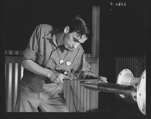 Production. Motor torpedo boats (wooden). Dressing down a key on a propeller shaft that will transmit the driving power of a new motor torpedo boat. The big Southern shipyard where many of these speedy wooden fighters are built also produces steel boats for the Navy