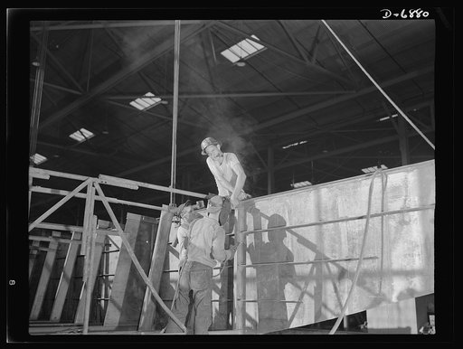 Production. Fifty-foot steel ramp boats. Working on the gunwale of a fifty-foot steel ramp boat used to land men, tanks and other equipment on hostile shores. The Southern boat plant that builds these boats also produces torpedo boats, wooden ramp boats and other Navy craft. Higgins Industries