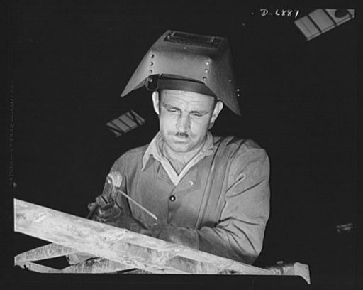 Manpower. Boatyard workers. An electric arc welder at a large Southern boatyard examines a bead he has just run on a steel ramp which will be used in making beach landings of men, tanks, and other equipment on hostile shores. The yard is also turning out motor torpedo boats, smaller wooden ramp boat