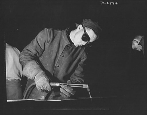 Production. Fifty-foot steel ramp boats. Gas welding a plate for a fifty-foot steel ramp boat in a Southern yard, building boats used in landing men, tanks and other equipment on hostile shores. Torpedo boats, smaller wooden ramp boats and other Navy craft are also made at this yard