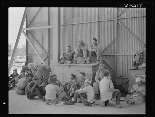 Manpower. Boatyard workers. Rest period for some of the workers at a Southern boatyard now producing steel ramp boats to be used in making beach landings of men, tanks and other equipment on enemy shores. The yard is also turning out motor torpedo boats, smaller wooden ramp boats and other Navy craf