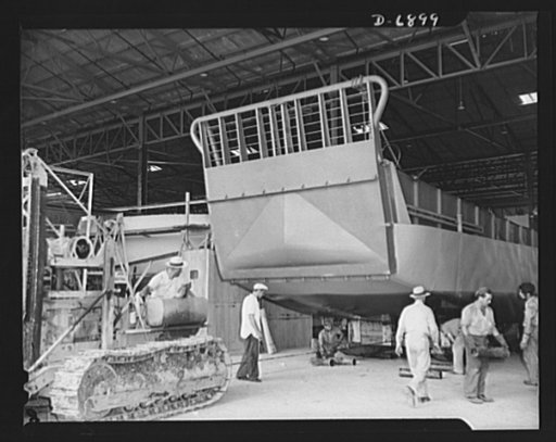 Production. Fifty-foot steel ramp boats. A new fifty-foot steel ramp boat, ready for launching, is rolled off the production line of a Southern boatyard. This boat will be used in making beach landings of men, tanks and other Navy craft