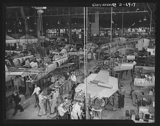 Production. Lockheed P-38 pursuit planes. "Mating" operation in the production of Lockheed P-38 pursuit planes. Previously assembled ship sections are joined together here to form the body of the plane. Feed lines from subassembly sections come to this point from three directions. Only a comparative