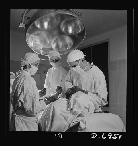 Nurse training. An important phase of every nurse's training is assisting at operations. In this emergency tracheotomy, the doctor is inserting a tube into the trachea as a nurse stands ready to hand him an instrument
