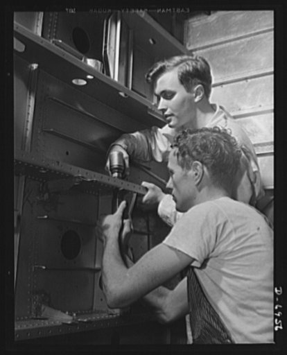Production. B-25 bombers. A riveting job in the center section of a B-25 bomber in a big Western aircraft plant. General Doolittle has called this ship the best military plane in existence. These men are typical of many who were trained at this plant for the various operations necessary to the makin