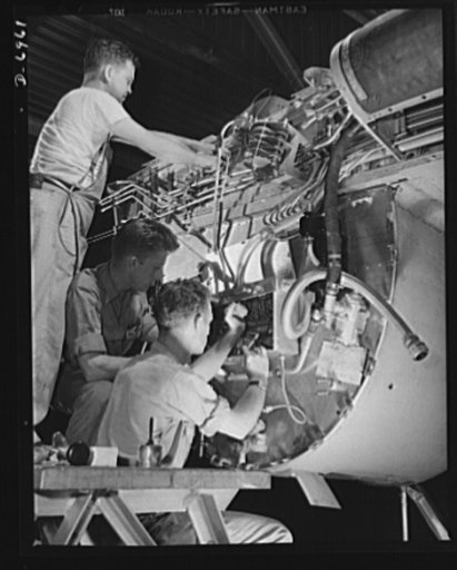 Production. B-25 bombers. Making wiring assemblies at a junction box on the fire wall for the right engine of a B-25 bomber. Forward of this wall will be mounted one of the two 1700 horsepower Wright Whirlwind engines which carry the B-25 through brilliant performances up to altitudes of 25,000 feet