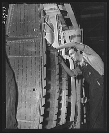 Production. B-25 bombers. A wing brace assembly for a B-25 bomber is prepared for the assembly line of a Western aircraft plant. General Doolittle has called the ship the best military plane in existence. With plenty of speed, a 1700-mile cruising range and a ceiling of 25,000 feet, it has performed