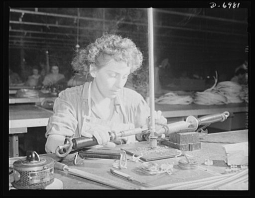 Production. B-25 bombers. Soldering an end fitting to a flexible conduit that will carry some of the complicated electrical wiring of a B-25 bomber. The Western plant in which these warships of the air are built employs many women at jobs that once were considered exclusively the work of men. Fairfa