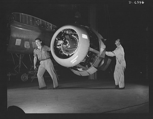 Production. B-25 bombers. A Wright Whirlwind engine ready for installation in a new B-25 medium bomber in a Western aircraft plant. The B-25 is driven by two of these 1700-horsepower engines which perform brilliantly at the plane's ceiling of 25,000 feet. Fairfax bomber plant, Kansas City