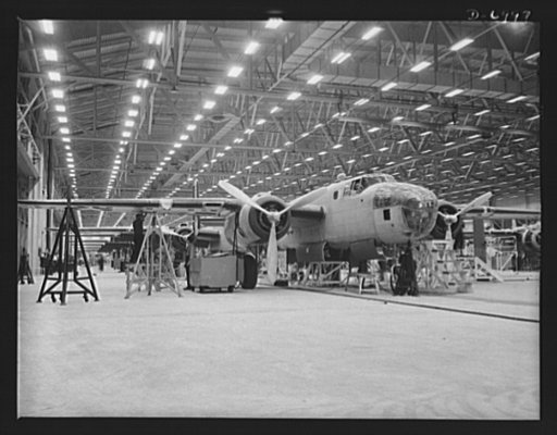 Production. B-25 bombers. It packs a wallop the Axis has felt. A new B-25 medium bomber nearing the end of a Western aircraft assembly line. General Doolittle calls it the best military plane in existence. Fairfax bomber plant, Kansas City